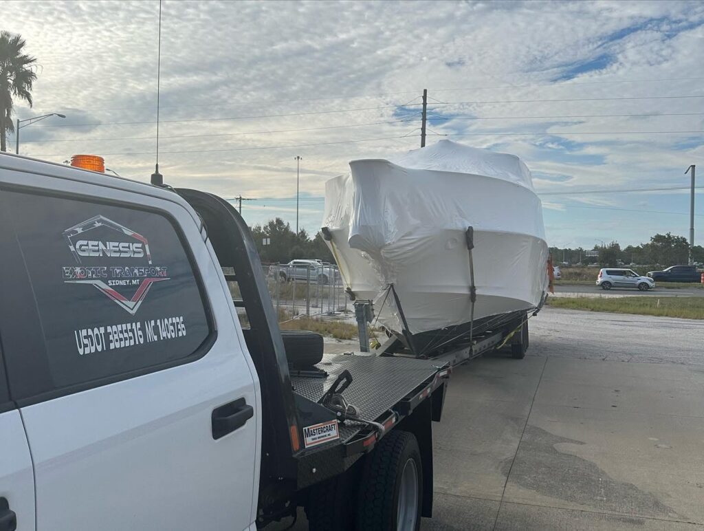 Boat being transported that was shrink wrapped by Genesis Exotic Transport.